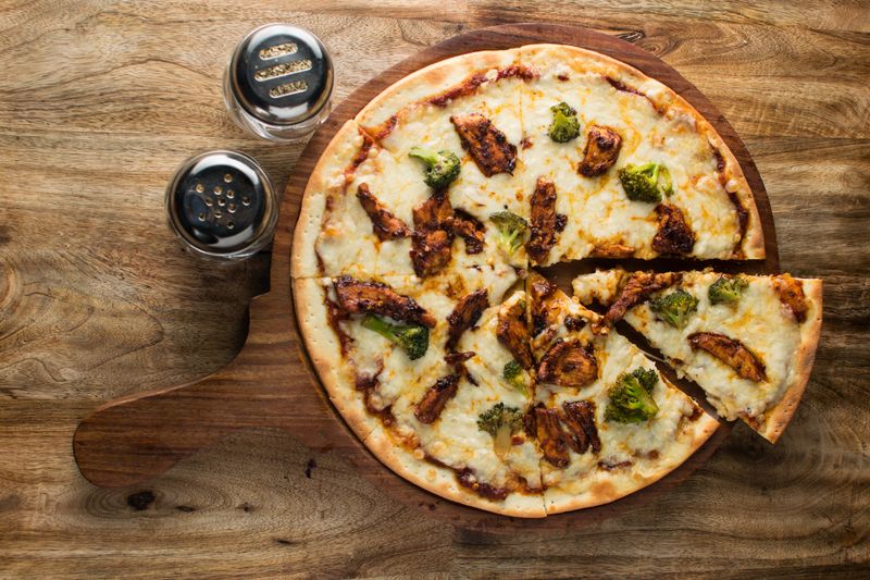 BBQ Chicken pizza with smoky sauce and caramelized onions